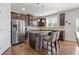 Kitchen features stainless steel appliances, dark cabinetry, and an island with seating at 4279 Two Bridge Dr, Buford, GA 30518