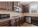 Well-equipped kitchen with granite countertops, stainless steel appliances, and dark wood cabinets at 4279 Two Bridge Dr, Buford, GA 30518
