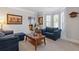 Bright living room featuring classic decor, comfortable seating, and large windows with plantation shutters at 4279 Two Bridge Dr, Buford, GA 30518