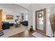 Inviting living room with neutral carpet, filled with natural light from the front door at 4279 Two Bridge Dr, Buford, GA 30518