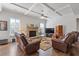 Comfortable living room features a stone fireplace, hardwood floors, and trey ceiling at 4279 Two Bridge Dr, Buford, GA 30518