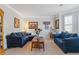 Cozy living room featuring plush seating, classic decor, and ample natural light from shuttered windows at 4279 Two Bridge Dr, Buford, GA 30518