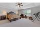 Large main bedroom featuring tray ceilings, ceiling fan, neutral walls, and plush carpet at 4279 Two Bridge Dr, Buford, GA 30518