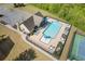 Aerial view of a sparkling community pool surrounded by lounge chairs and tables at 4279 Two Bridge Dr, Buford, GA 30518
