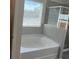 Bright bathroom featuring a tub and separate shower with modern fixtures at 4520 Ajo Walk, Atlanta, GA 30331