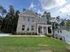 New two-story brick home boasts a manicured lawn and welcoming covered porch at 4520 Ajo Walk, Atlanta, GA 30331