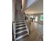 Staircase leads to an open living area with wood-look floors and bright kitchen at 4520 Ajo Walk, Atlanta, GA 30331
