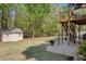 Spacious backyard with storage shed, well maintained lawn, and stairs to a wooden deck at 3311 Lost Meadows Ln, Buford, GA 30519