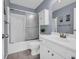 Well-lit bathroom featuring a white vanity, shower with glass doors, and tile flooring at 3311 Lost Meadows Ln, Buford, GA 30519