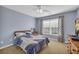 Comfortable bedroom with a blue comforter set, plush carpet, and large window at 3311 Lost Meadows Ln, Buford, GA 30519