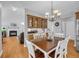 Dining room features an elegant chandelier, and seamless transition into the living area at 3311 Lost Meadows Ln, Buford, GA 30519