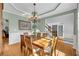 Dining room featuring wood table and chairs and chandelier lighting at 3311 Lost Meadows Ln, Buford, GA 30519