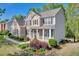 Beautiful two-story home with manicured lawn and charming front garden at 3311 Lost Meadows Ln, Buford, GA 30519