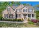 Charming two-story brick home with well-manicured lawn and covered porch at 3311 Lost Meadows Ln, Buford, GA 30519