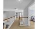 Second-floor hallway with wood railing and plenty of natural light at 3311 Lost Meadows Ln, Buford, GA 30519