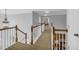 Bright hallway with wood railing and views of the home's interior at 3311 Lost Meadows Ln, Buford, GA 30519