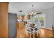 Bright eat-in kitchen with stainless steel appliances and beautiful hardwood floors, perfect for modern living at 3311 Lost Meadows Ln, Buford, GA 30519