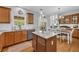 Spacious kitchen and dining area featuring an island and seamless transition to the living space at 3311 Lost Meadows Ln, Buford, GA 30519