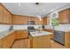 Modern kitchen with granite countertops, white tile backsplash, stainless steel appliances, and a central island at 3311 Lost Meadows Ln, Buford, GA 30519