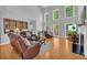 Open living room with tall windows, a fireplace, and seamless flow to the dining area at 3311 Lost Meadows Ln, Buford, GA 30519