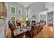Elegant living room with fireplace, hardwood floors, large windows, and soaring ceilings at 3311 Lost Meadows Ln, Buford, GA 30519