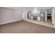 Room featuring tan carpeting, light gray walls, tile flooring, cabinets, a stainless steel refrigerator, and stools at 3311 Lost Meadows Ln, Buford, GA 30519