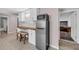 Room featuring tile flooring, cabinets, a stainless steel refrigerator, stools, and a small window at 3311 Lost Meadows Ln, Buford, GA 30519