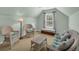 Bright sitting area with carpet and white wicker furniture in the main bedroom at 3311 Lost Meadows Ln, Buford, GA 30519