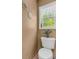 Powder room with decorative accents and natural lighting from a window at 3311 Lost Meadows Ln, Buford, GA 30519