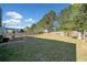 Large backyard featuring a lush lawn, privacy fence, and mature trees at 419 Farmwood Way, Canton, GA 30115