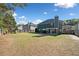 Spacious backyard, enclosed with wood fence for privacy, mature trees, and a covered patio at 419 Farmwood Way, Canton, GA 30115