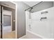 Clean, tiled bathtub and shower combo, with a view into the doorway of the bathroom at 419 Farmwood Way, Canton, GA 30115