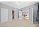 This spacious bedroom features double doors that open to a view of the stairs and living room at 419 Farmwood Way, Canton, GA 30115