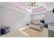 Bright bedroom with tray ceiling, a ceiling fan, and large window at 419 Farmwood Way, Canton, GA 30115