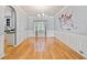 Elegant dining room with hardwood floors, wainscoting, modern chandelier, and a decorative wall map at 419 Farmwood Way, Canton, GA 30115