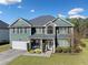 Charming two-story home with green siding, a well-manicured lawn, and an attached two-car garage at 419 Farmwood Way, Canton, GA 30115