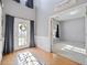 Bright foyer with hardwood floors, soaring ceilings, and a view into an adjacent room at 419 Farmwood Way, Canton, GA 30115