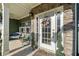 Close-up of front door with sidelights and porch with seating at 419 Farmwood Way, Canton, GA 30115