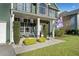 Inviting front porch with stone accents, hanging floral baskets, and a comfortable seating area at 419 Farmwood Way, Canton, GA 30115