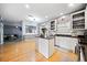 Open kitchen features an island, stainless steel appliances, and wood floors at 419 Farmwood Way, Canton, GA 30115