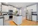 Open kitchen with center island, stainless steel appliances, and ample cabinet space at 419 Farmwood Way, Canton, GA 30115