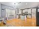 Bright kitchen with stainless steel appliances, granite countertops, and a central island with white cabinetry at 419 Farmwood Way, Canton, GA 30115