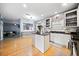 Open kitchen featuring an island with dark countertops, white cabinets, and stainless appliances at 419 Farmwood Way, Canton, GA 30115