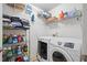 Organized laundry room featuring modern washer and dryer units, ample shelving, and storage for cleaning supplies at 419 Farmwood Way, Canton, GA 30115