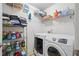 Well-organized laundry room with shelving and front load washer and dryer at 419 Farmwood Way, Canton, GA 30115