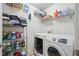 Organized laundry room with shelving, washer, and dryer, making laundry chores efficient and convenient at 419 Farmwood Way, Canton, GA 30115