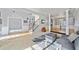 Open-concept living room with hardwood floors, neutral tones, and a seamless flow to the dining area at 419 Farmwood Way, Canton, GA 30115