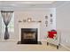 Relaxing living room featuring neutral carpet and a classic fireplace at 419 Farmwood Way, Canton, GA 30115