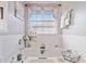 Bright main bathroom showcasing a soaking tub with elegant fixtures and natural light at 419 Farmwood Way, Canton, GA 30115