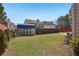 Large backyard featuring a storage shed, green grass, and a privacy fence at 4316 Constellation Blvd, Snellville, GA 30039